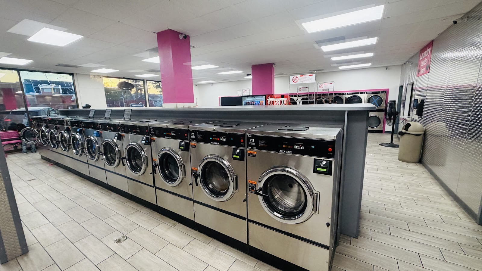 Wide interior view of a long row of Dexter washers