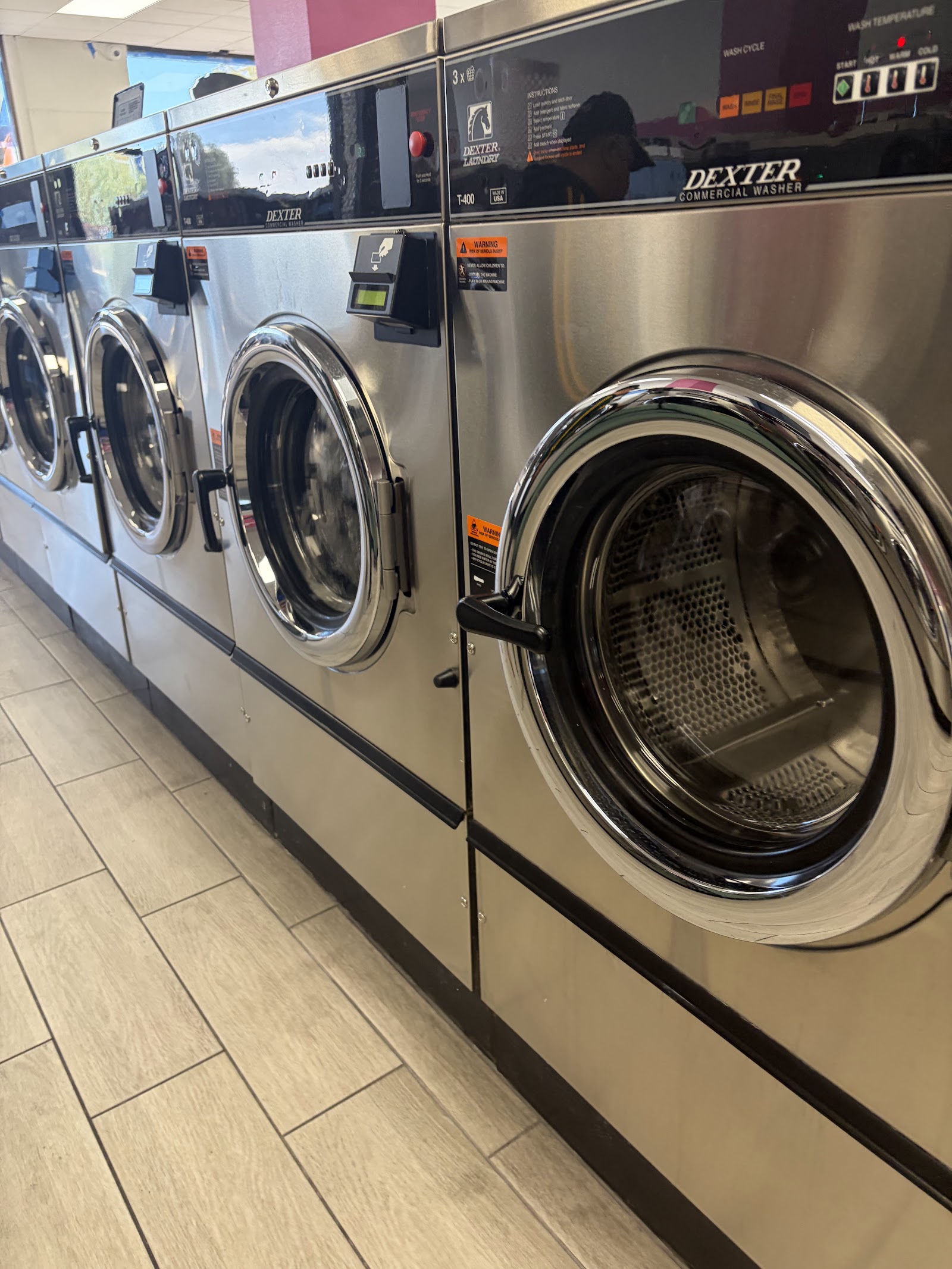 Row of Dexter commercial front-load washers with open doors
